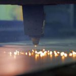 A close up view of a machine engaging in fiber laser cutting
